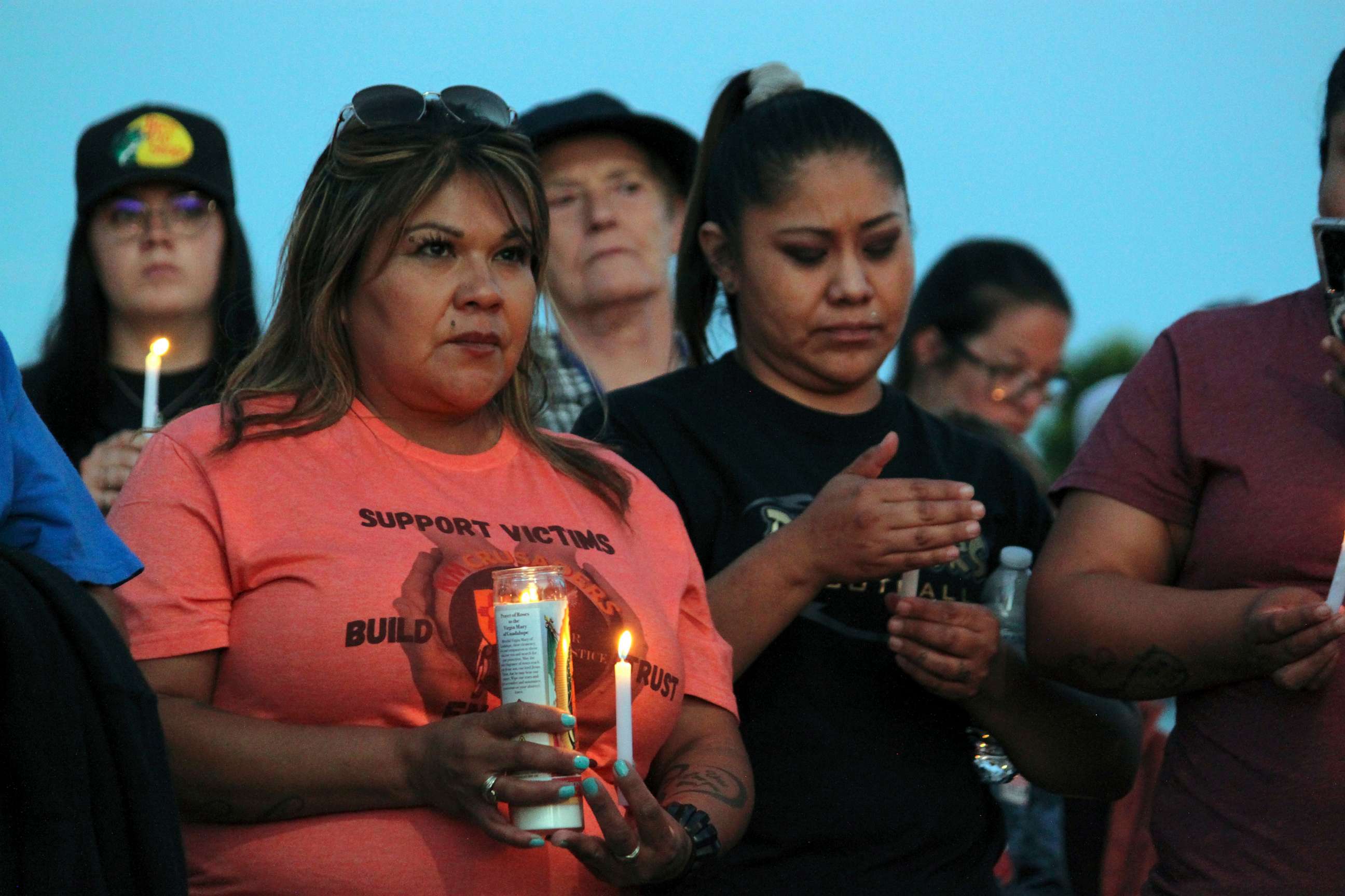 PHOTO: Community members hold candles during a prayer vigil at Hills Church, May 15, 2023, in Farmington, N.M., after a gunman killed three people and injured six others including two police officers before he was killed.