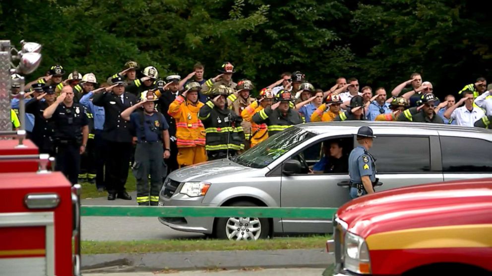 PHOTO: Firefighters salute outside of the Medical Examiner's Office after a firefighter was killed in an explosion in Farmington, Maine, Sept. 16, 2019.