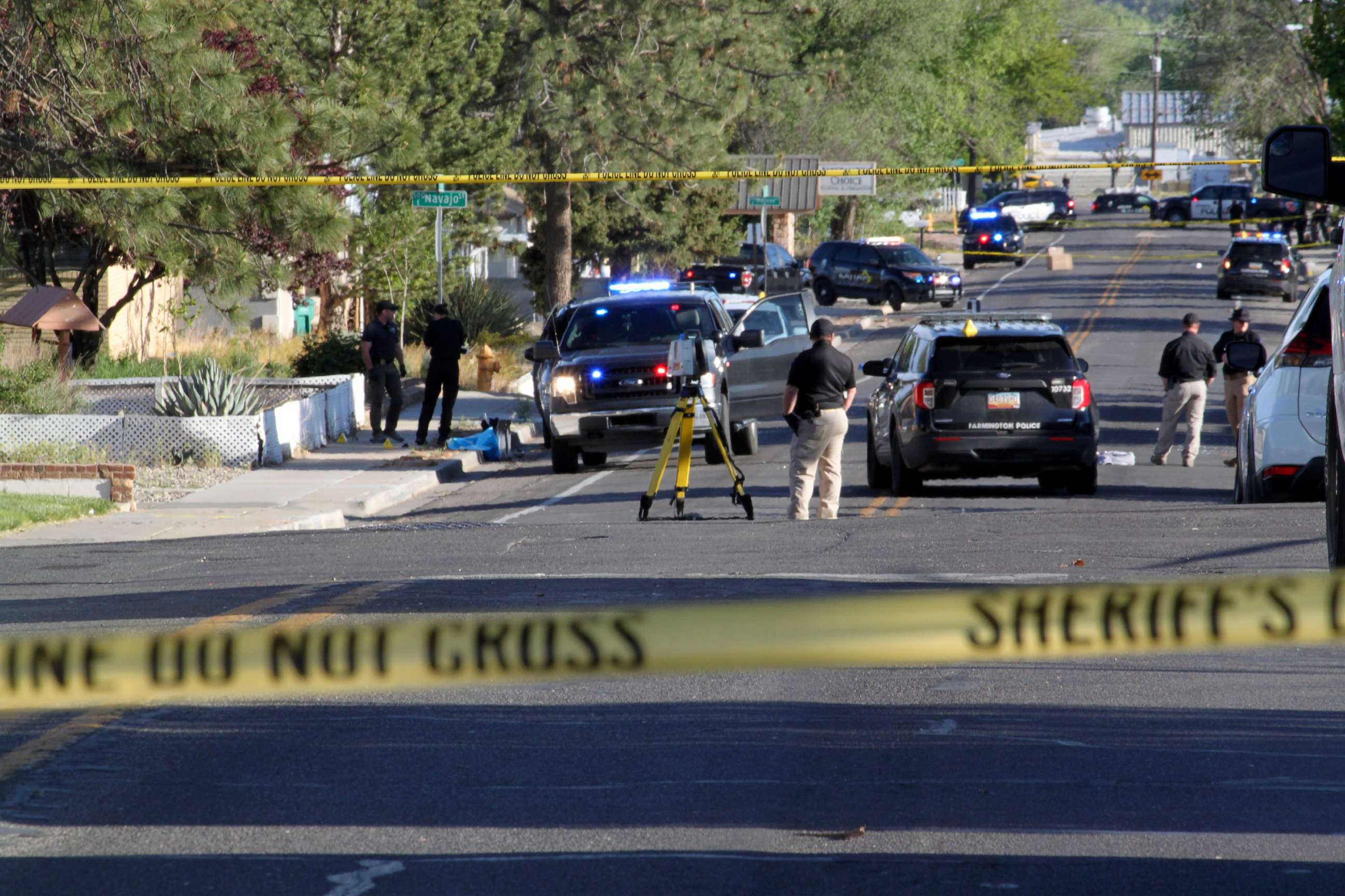 PHOTO: Investigators work along a residential street following a deadly shooting, May 15, 2023, in Farmington, N.M.