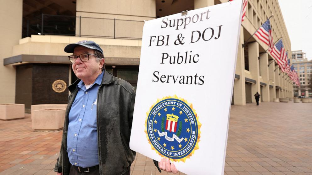 PHOTO: Stephen Butterfield of D.C. holds a sign outside the FBI headquarters showing his support for the FBI and Department of Justice employees in Washington, Feb. 3, 2025.