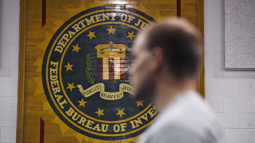 PHOTO: A new agent trainee walks by the FBI seal on a wall at the FBI Academy in Quantico, Va., in 2012.
