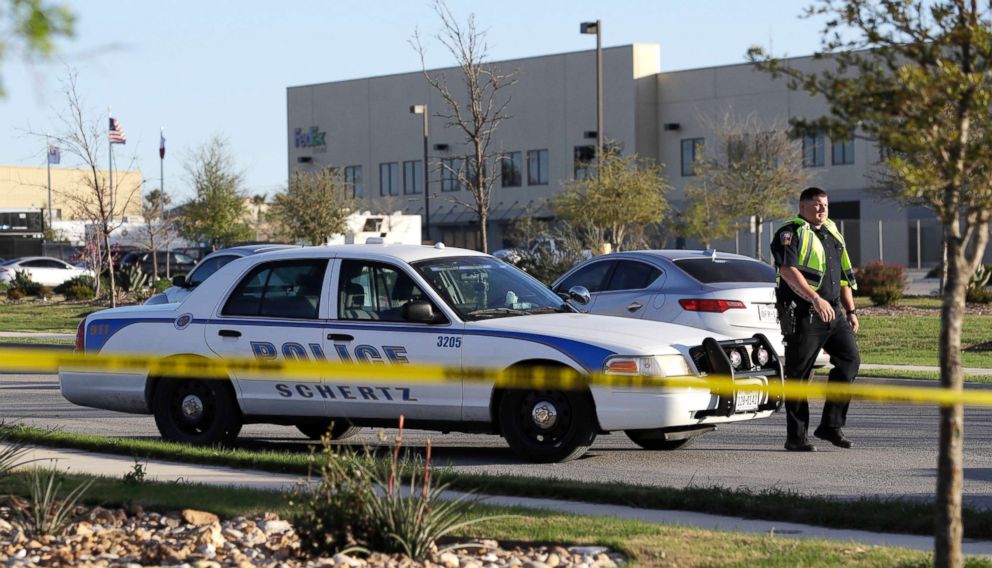 PHOTO: A police officer stops a vehicle at a check point in front of a FedEx distribution center where a package exploded, March 20, 2018, in Schertz, Texas. 