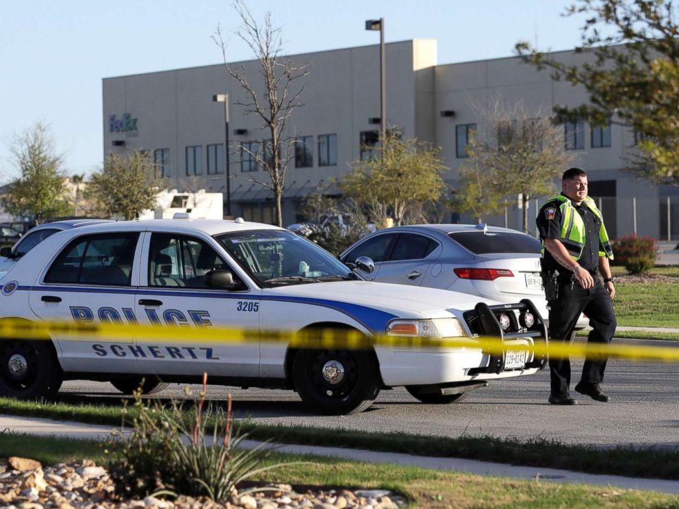 PHOTO: A police officer stops a vehicle at a check point in front of a FedEx distribution center where a package exploded on March 20, 2018, in Schertz, Texas.