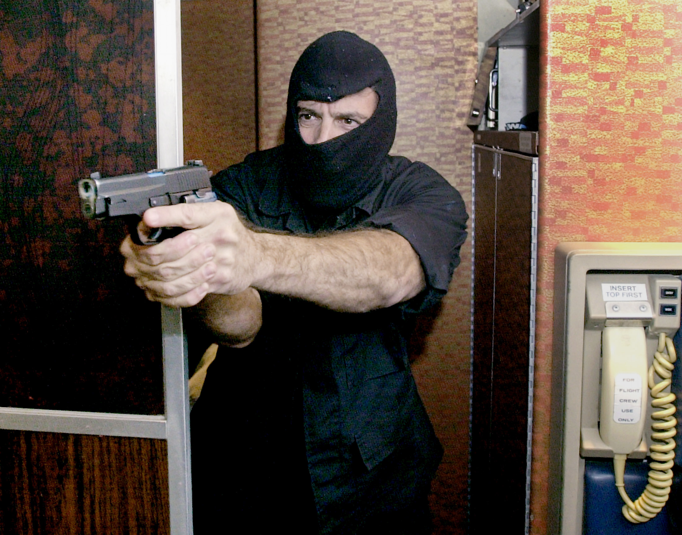 PHOTO: A Federal Aviaition Administration Sky Marshal wields a pistol during a simulated hijacking aboard a retired aircraft at the FAA training facility in Pomona, N.J. on Sept. 26, 2001.