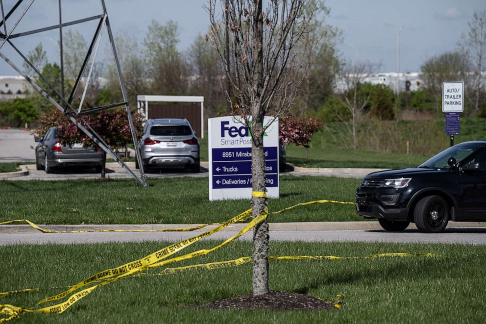 PHOTO: A tree wrapped in caution tape is seen near the parking lot of a FedEx facility that was the scene of a mass shooting that left eight people dead, April 16, 2021,  in Indianapolis.