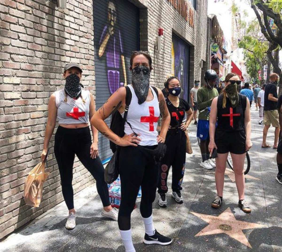 PHOTO: Volunteers from the group "Feed the Streets LA" serve protesters with matching cross t-shirts and provide medical aid to those hurt while marching in Los Angeles, California in wake of George Floyd's death.