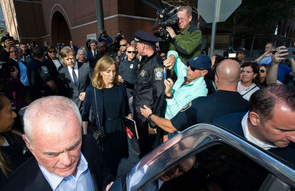 PHOTO: Actress Felicity Huffman, escorted by her husband William H. Macy, makes her way to a waiting SUV after leaving the courthouse in Boston, where she was sentenced for her role in the College Admissions scandal on September 13, 2019.