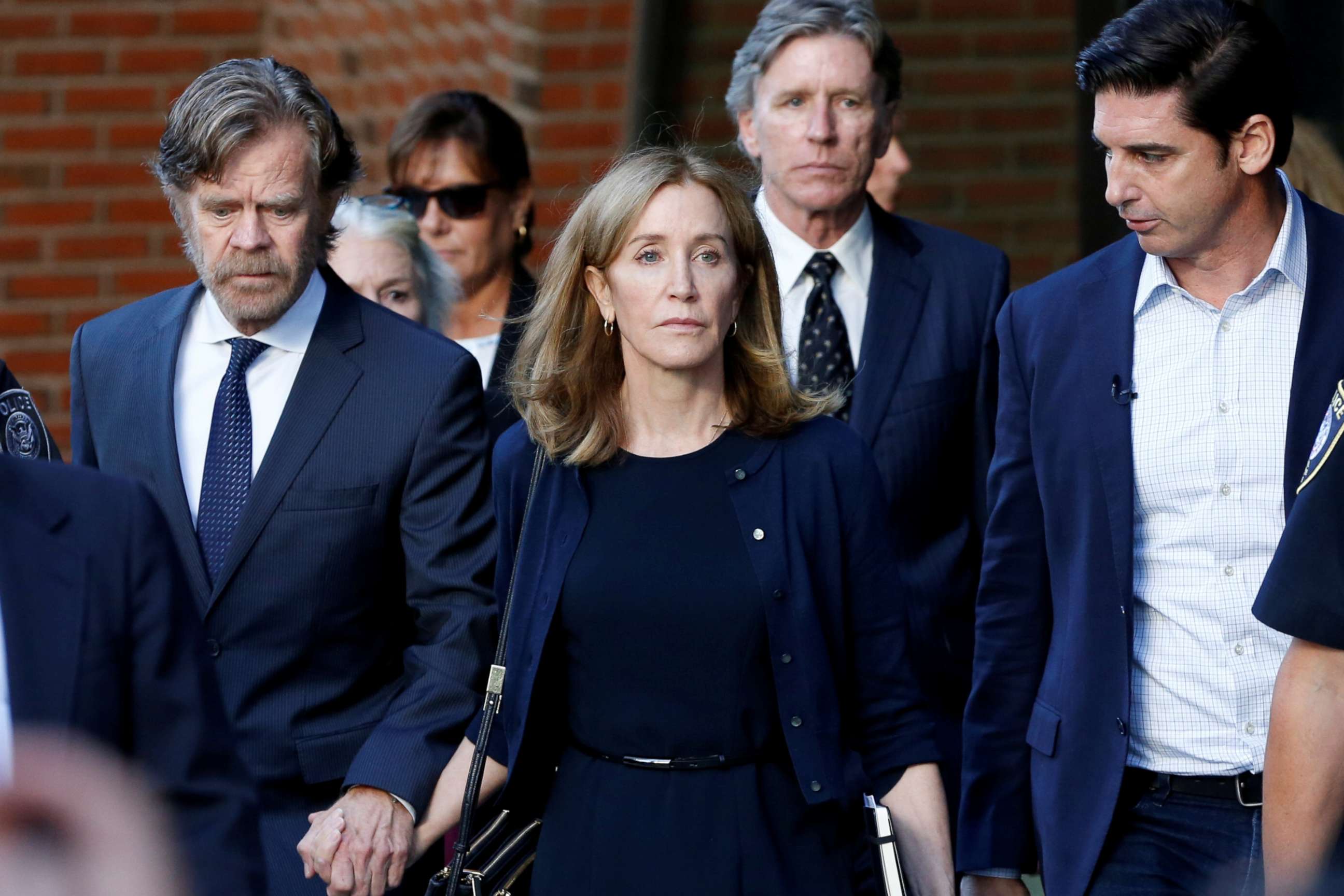PHOTO: Actress Felicity Huffman, center, leaves the federal courthouse with her husband William H. Macy after being sentenced in connection with a nationwide college admissions cheating scheme in Boston, M.A., on Sept. 13, 2019.