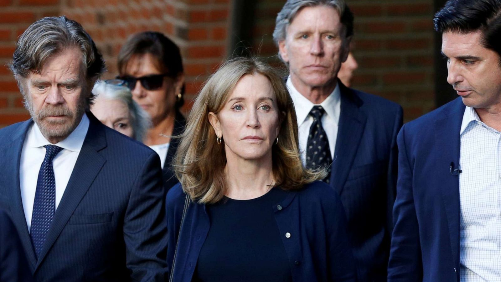 PHOTO: Actress Felicity Huffman, center, leaves the federal courthouse with her husband William H. Macy after being sentenced in connection with a nationwide college admissions cheating scheme in Boston, M.A., on Sept. 13, 2019.