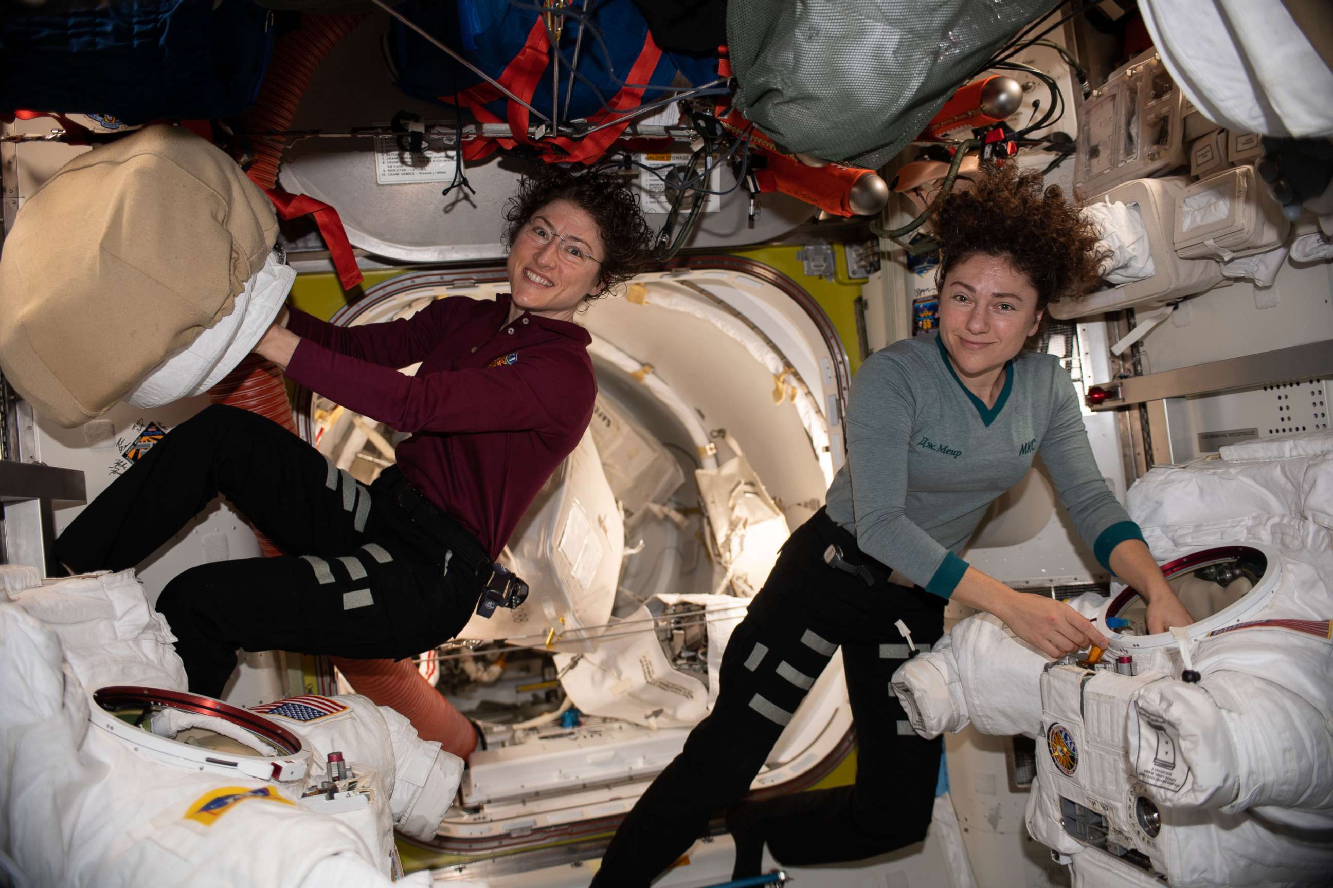 PHOTO: NASA astronauts Christina Koch and Jessica Meir work on their spacesuits ahead of a spacewalk they conducted to install new batteries that store and distribute power collected from solar arrays on the International Space Station, Jan. 15, 2020.