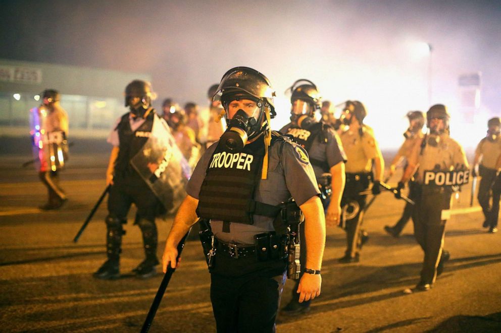 PHOTO: Police advance through a cloud of tear gas toward demonstrators protesting the killing of teenager Michael Brown, Aug. 17, 2014, in Ferguson, Missouri.