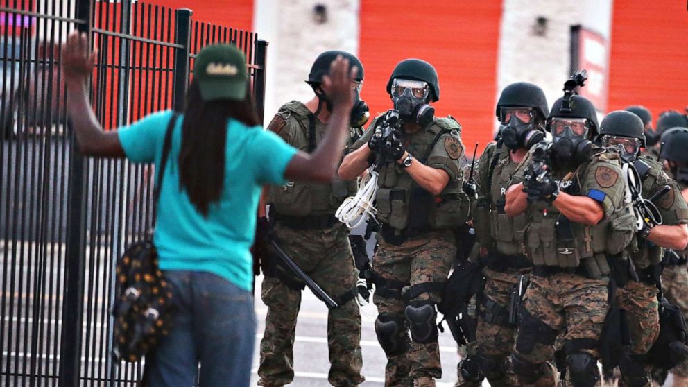 PHOTO: Police force protestors from the business district into nearby neighborhoods, on Aug. 11, 2014, in Ferguson, Missouri.