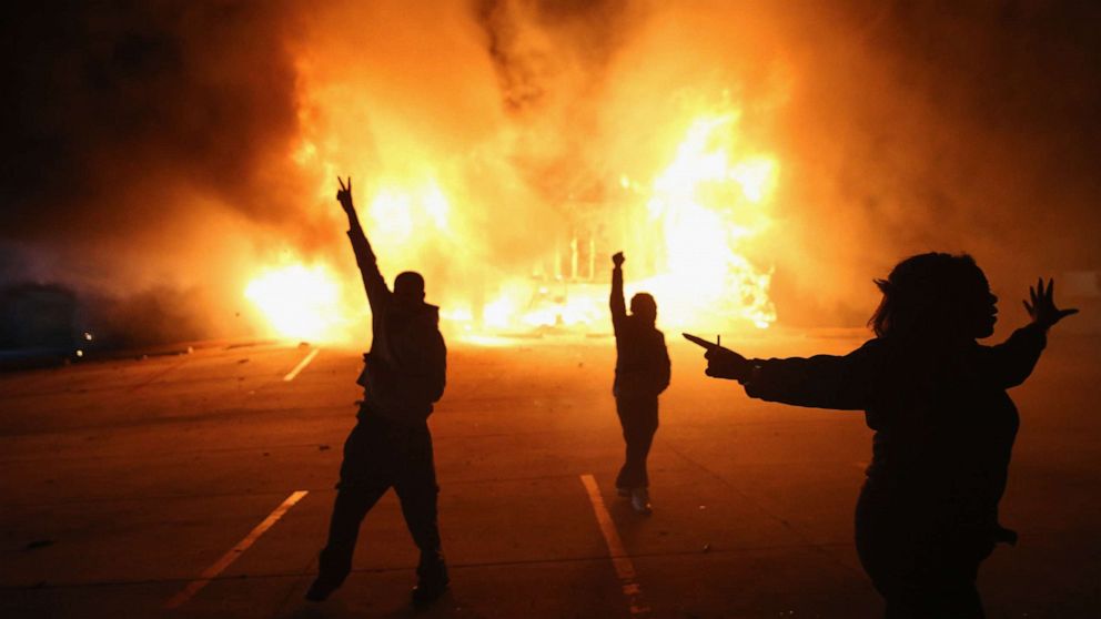 PHOTO: People demonstrate as a business burns during rioting following the grand jury announcement in the Michael Brown case, on Nov. 24, 2014, in Ferguson, Missouri.