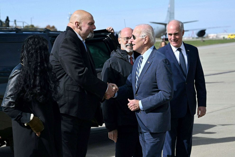PHOTO: President Joe Biden is greeted by Pennsylvania Lieutenant Governor John Fetterman after disembarking Air Force One at Philadelphia International Airport in Philadelphia on October 20, 2022.