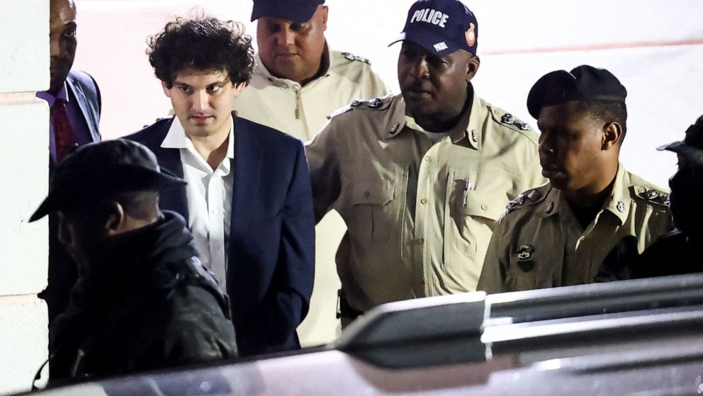 PHOTO: Sam Bankman-Fried, who founded and led FTX until a liquidity crunch forced the cryptocurrency exchange to declare bankruptcy, is escorted out of the Magistrate Court building after his arrest in Nassau, Bahamas, Dec. 13, 2022.