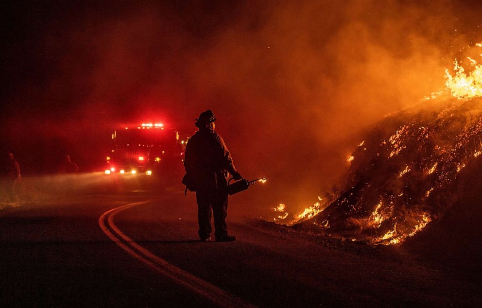 PHOTO: A firefighter lights a back fire during the Kincade fire near Geyserville, California on October 24, 2019. 