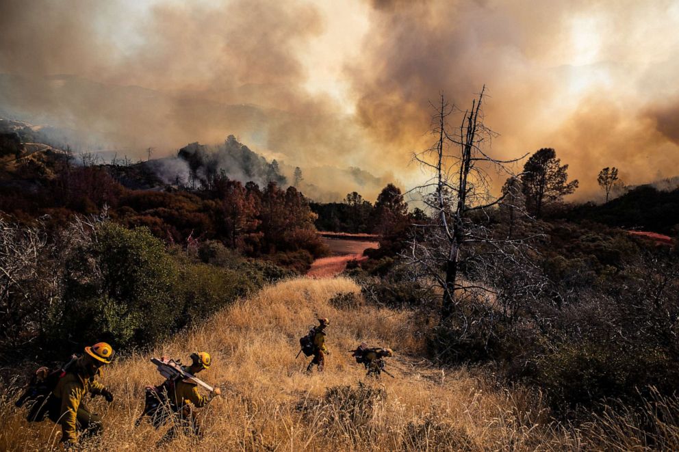 PHOTO: Firefighters with the Marin County Fire Department begin to dig a containment line ahead of the Kincade Fire, in the Geysers, a geothermal field in California on Friday, Oct. 25, 2019.