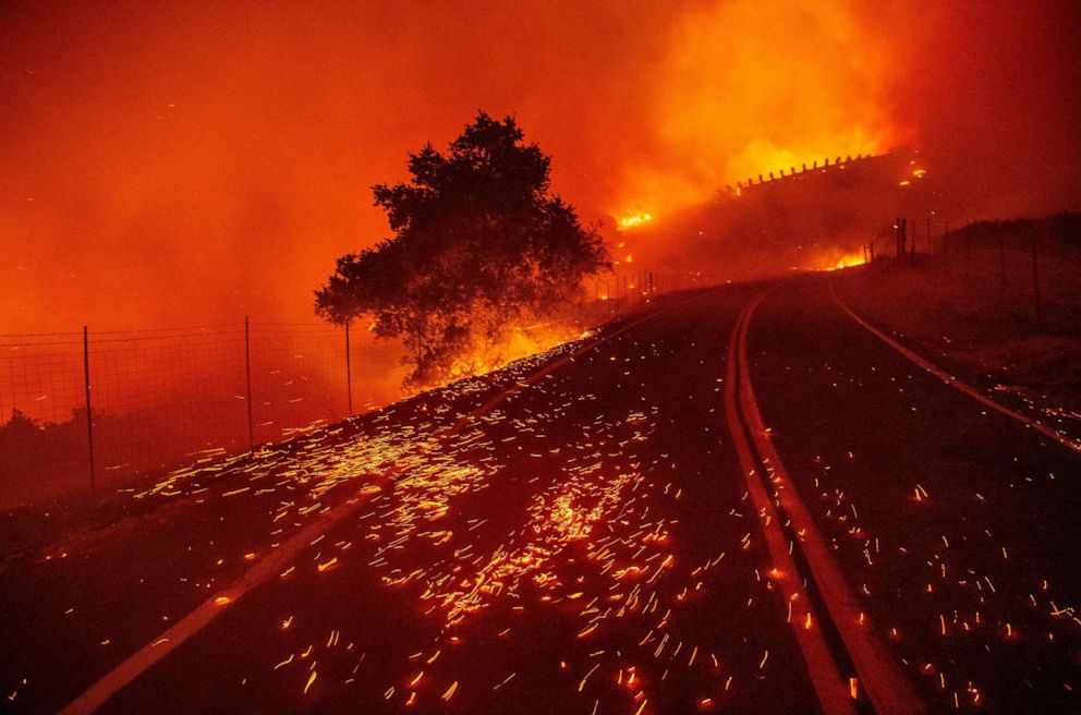 PHOTO: Embers blow across a road as wind rips through the area during the Kincade Fire near Geyserville, California on October 24, 2019.