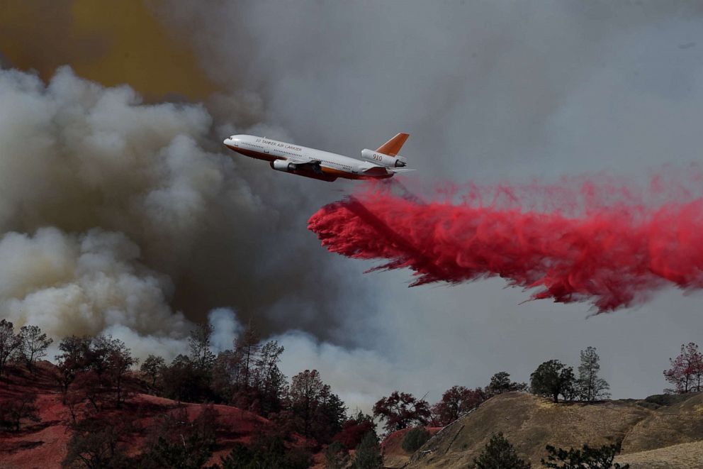 PHOTO: A fire fighting aircraft intervene in a fire broke out at Geyserville town in Sonoma County, California, United States on October 25, 2019.