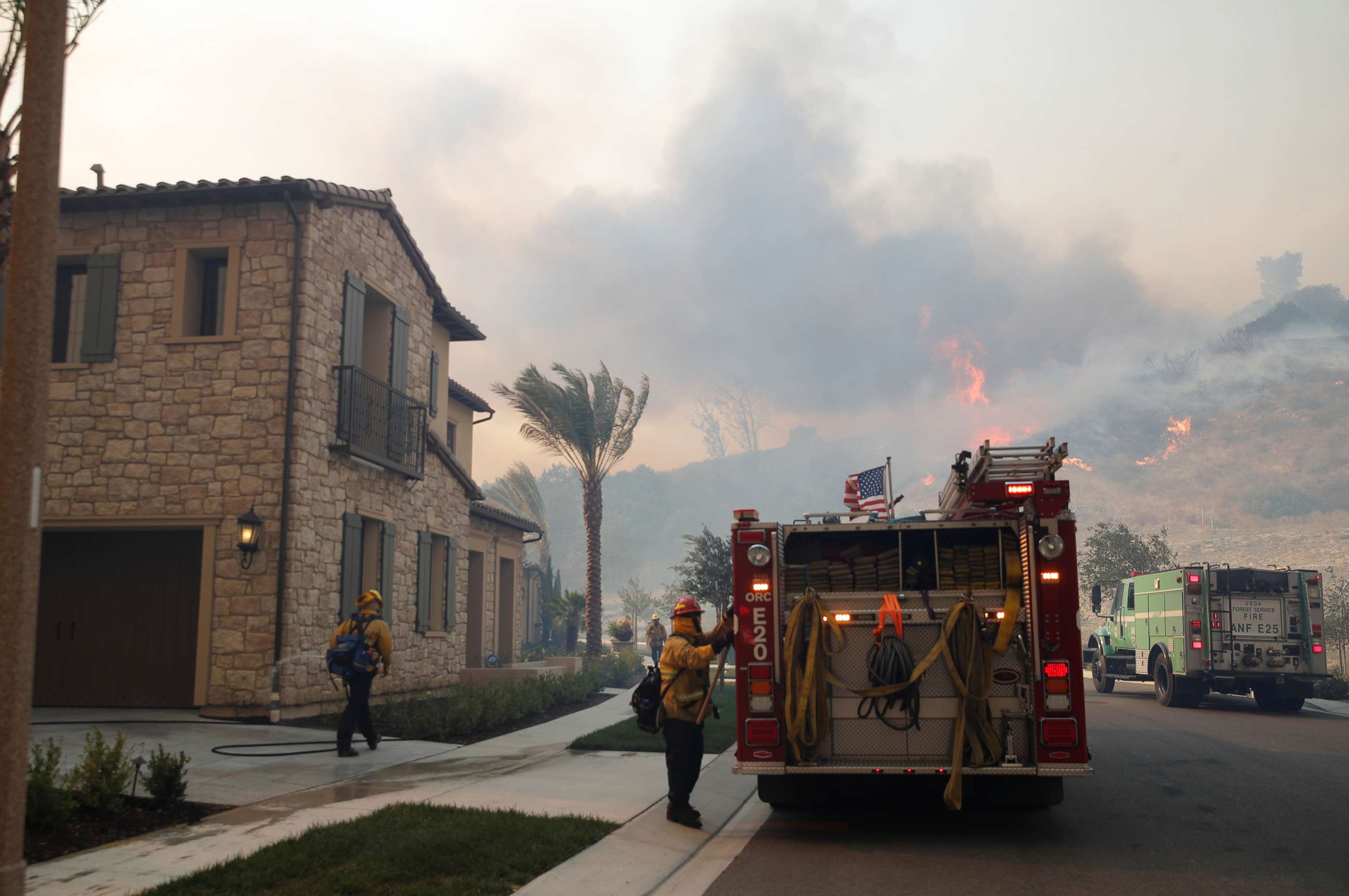 PHOTO: Firefighters are seen as the Silverado Fire approaches, near Irvine, Calif., Oct. 26, 2020. 