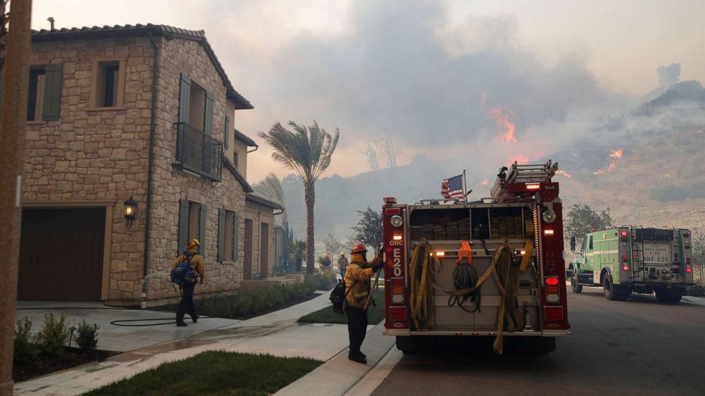 PHOTO: Firefighters are seen as the Silverado Fire approaches, near Irvine, Calif., Oct. 26, 2020. 