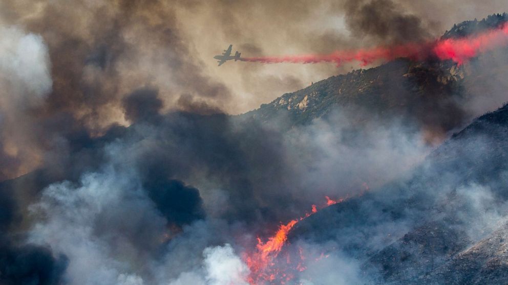 PHOTO: An air tanker drops retardant at a wildfire burns at a hillside in Yucaipa, Calif., Sept. 5, 2020. 