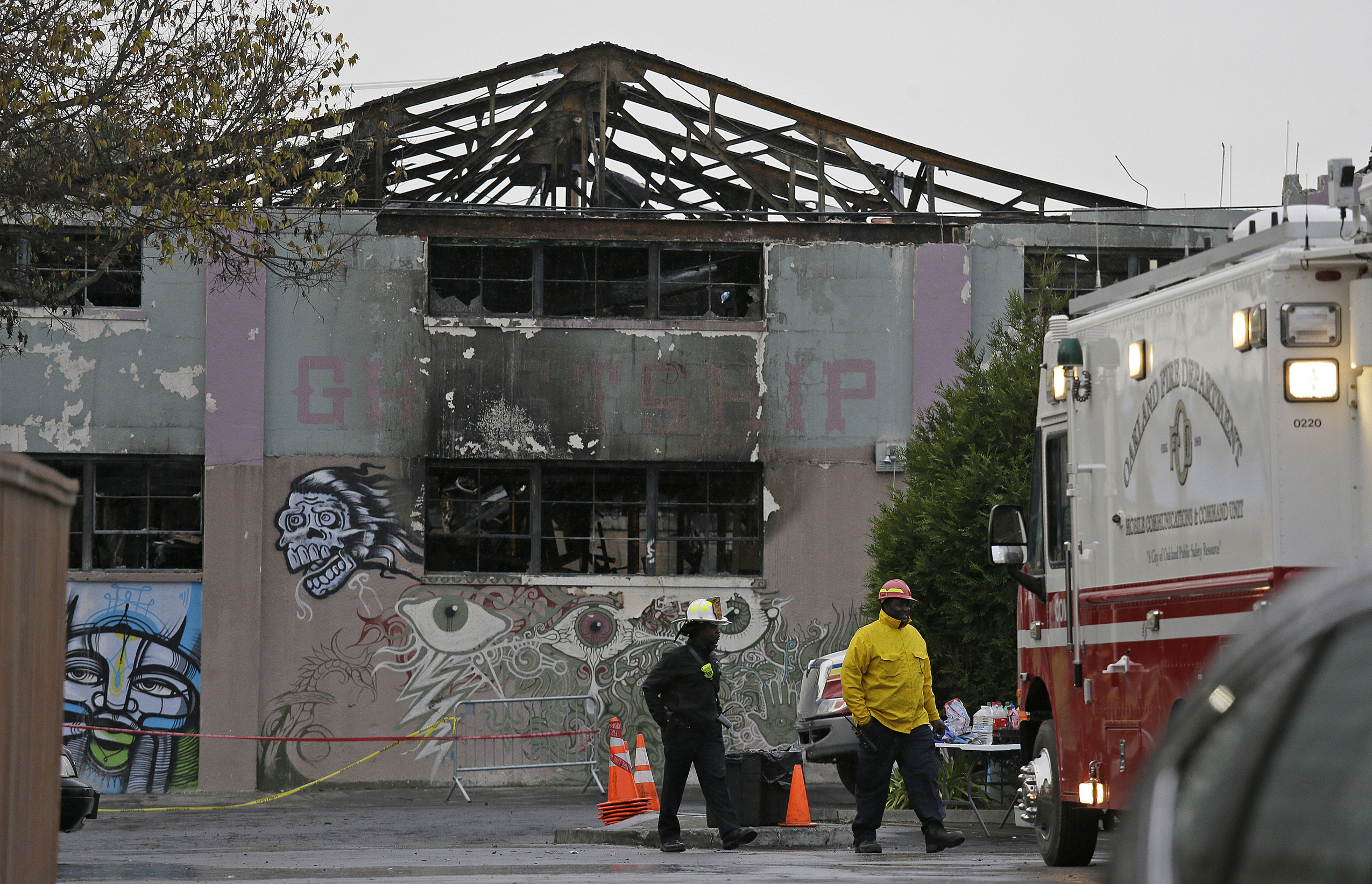 PHOTO: In this Dec. 7, 2016 file photo Oakland fire officials walk past the remains of the Ghost Ship warehouse damaged from a deadly fire in Oakland, Calif.