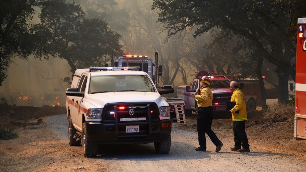 PHOTO: Firefighters coordinate the ground fire attack on the Rices Fire, June 28, 2022, off of Troost Trail, in North San Juan, Calif.