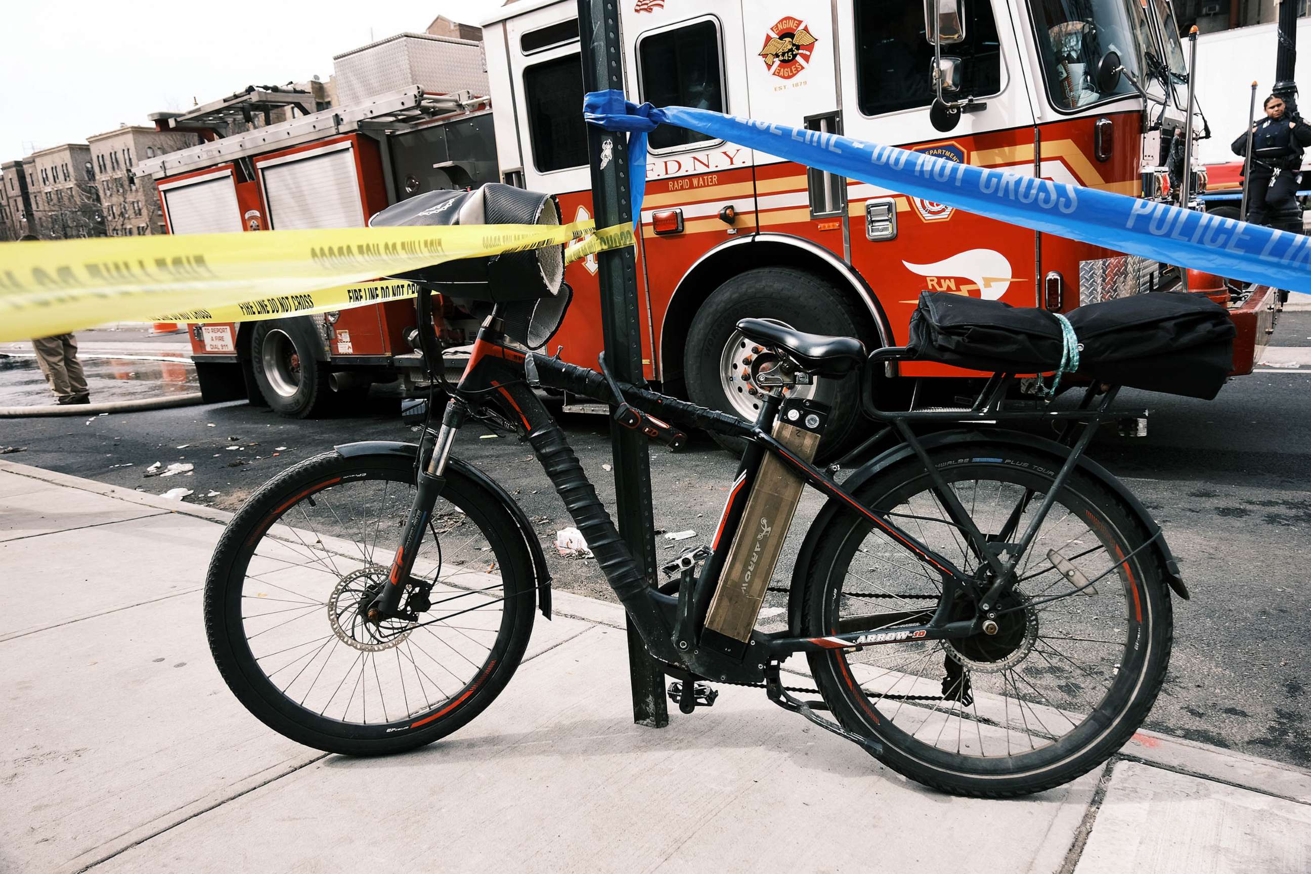 PHOTO: FILE - An electric bike with a battery sits parked outside of a Bronx supermarket the day after a 5-alarm fire tore through a market that fire officials are blaming on a faulty lithium-ion battery, March 06, 2023 in New York City.