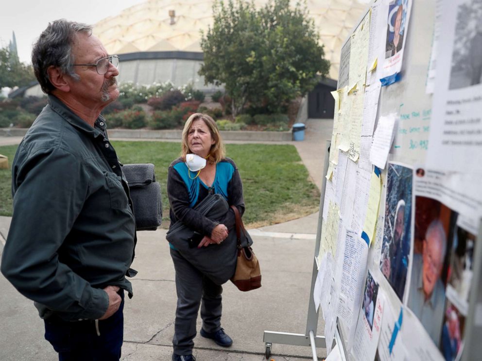 PHOTO: Lane and Julie Walker, of Magalia, look for people they know on a list of people missing in the aftermath of the Camp Fire in Chico, Calif., Nov. 15, 2018.