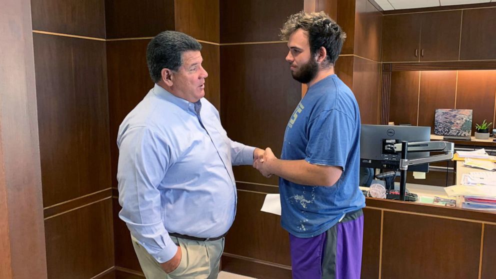 PHOTO: Mayor Tony Roswarski greets Nicholas Bostic, right, to thank him for rescuing five children from a house fire in Lafayette, Ind.