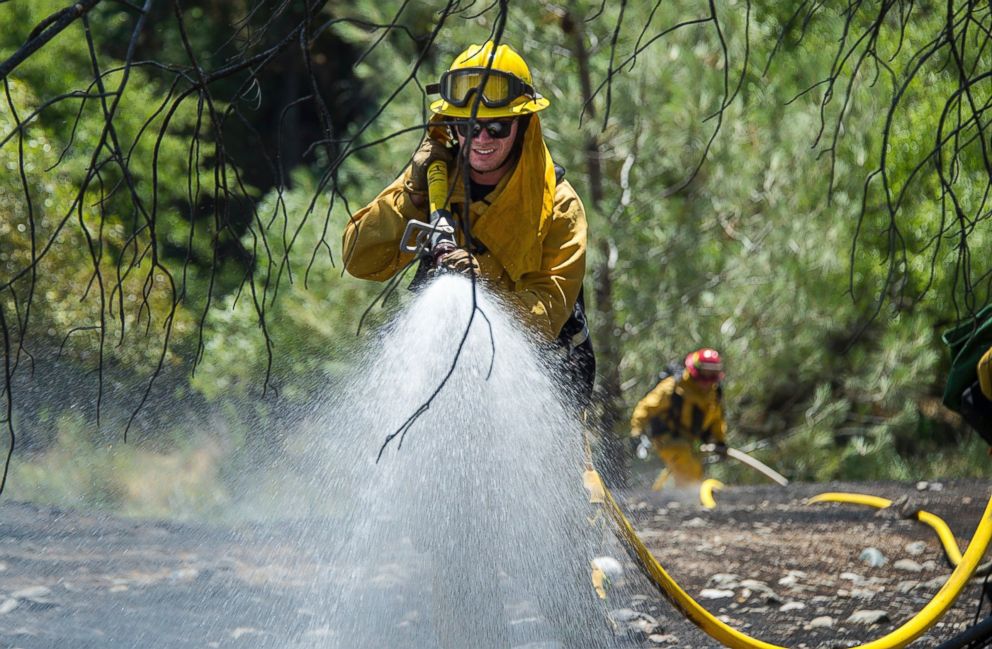 Fire crews battle the Pawnee Fire on Cache Creek Road on Monday in Spring Valley, California.