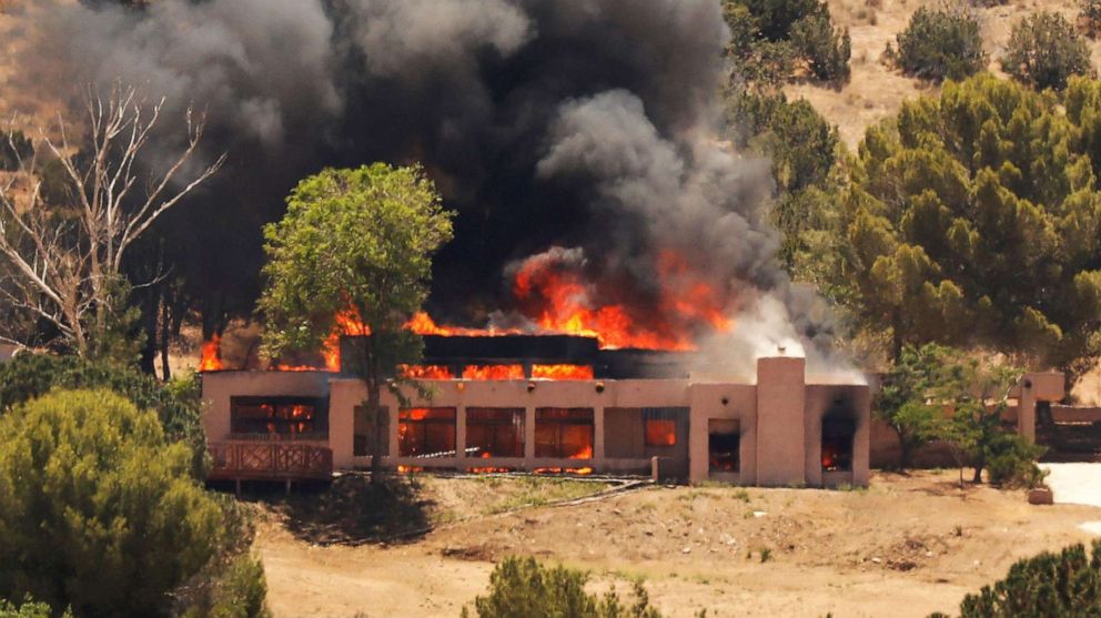 PHOTO: A burning home in Agua Dulce, Calif. believed to be the home of an off-duty firefighter who was involved in a shooting at the Agua Dulce fire station, June 1, 2021. 