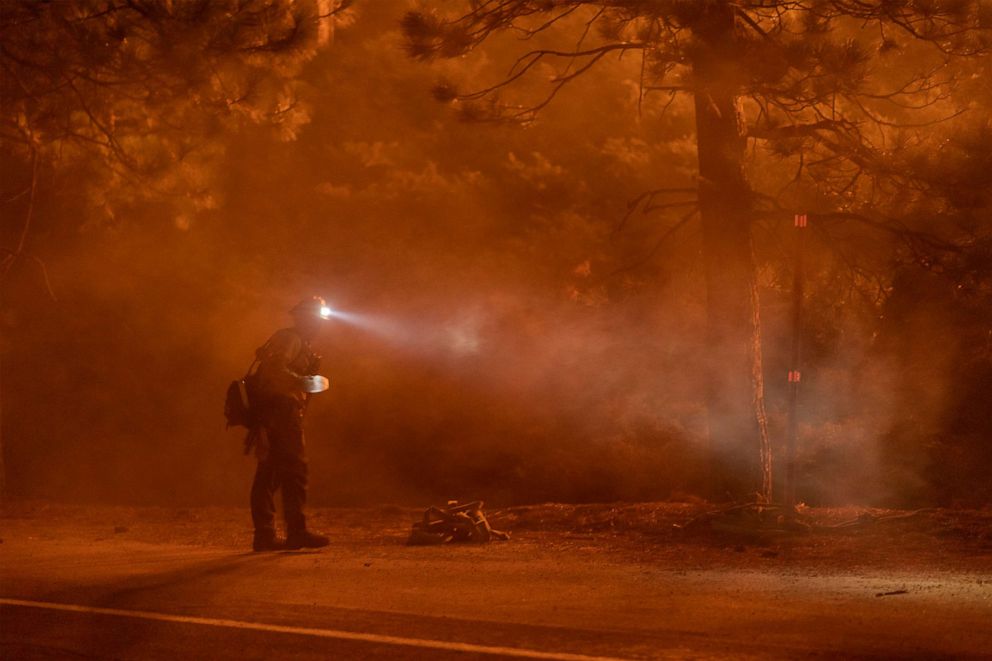 PHOTO: A firefighter keeps watch on flames that could jump the Angeles Crest Highway at the Bobcat Fire in the Angeles National Forest on Sept. 11, 2020, north of Monrovia, Calif. 