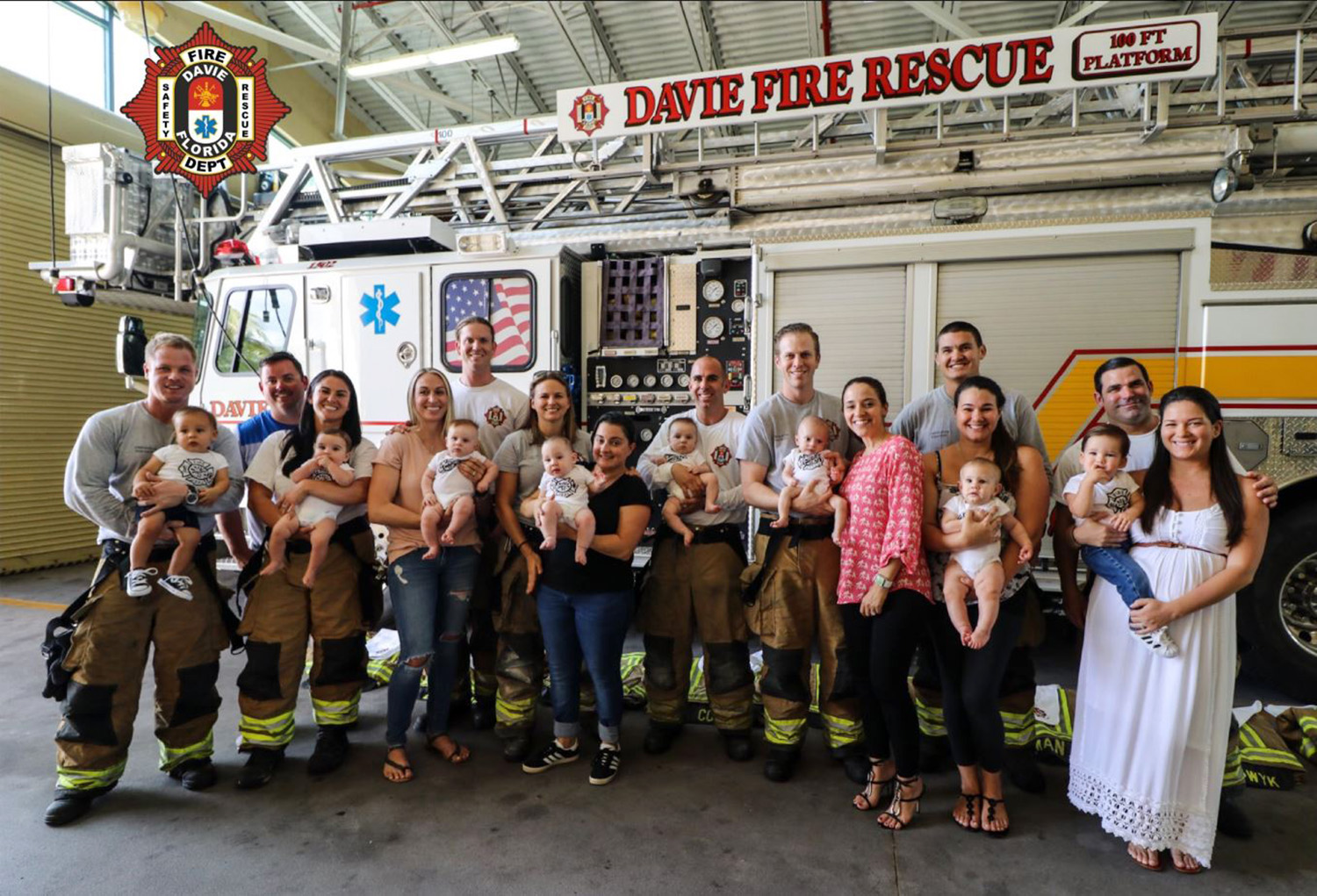 PHOTO: Firefighters in Davie, Fla, pose for a group photo with family members and babies all born in less than a year.