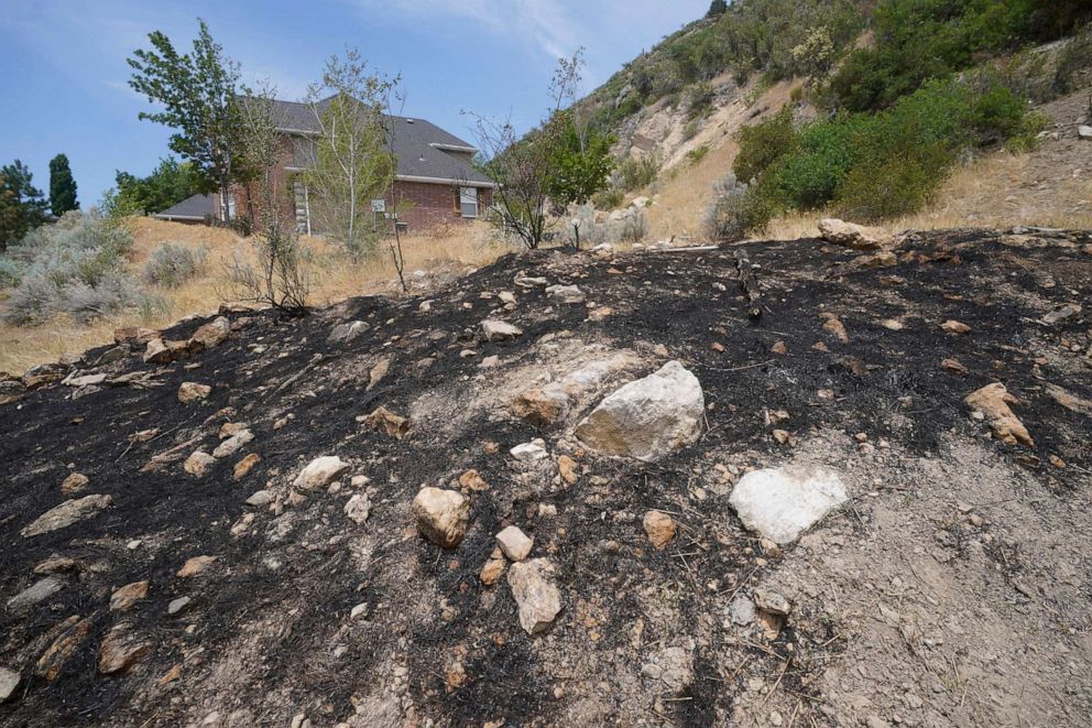 PHOTO: A burnt hillside caused by fireworks is shown June 22, 2021, in Provo, Utah. With a megadrought gripping the West, officials are enacting bans, canceling displays or begging people to be careful when lighting fireworks. 