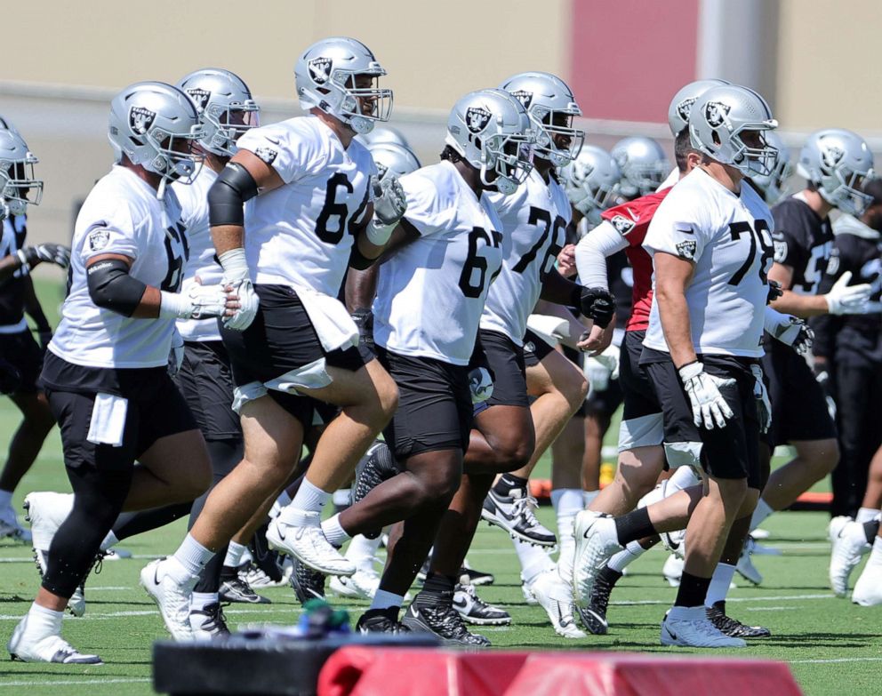 PHOTO: Offensive linemen Hroniss Grasu and Alex Bars, guards Lester Cotton Sr. and 
John Simpson and tackle Jackson Barton of the Las Vegas Raiders warm up during mandatory minicamp at the Las Vegas Raiders Headquarter in Henderson, Nev., June 7, 2022.