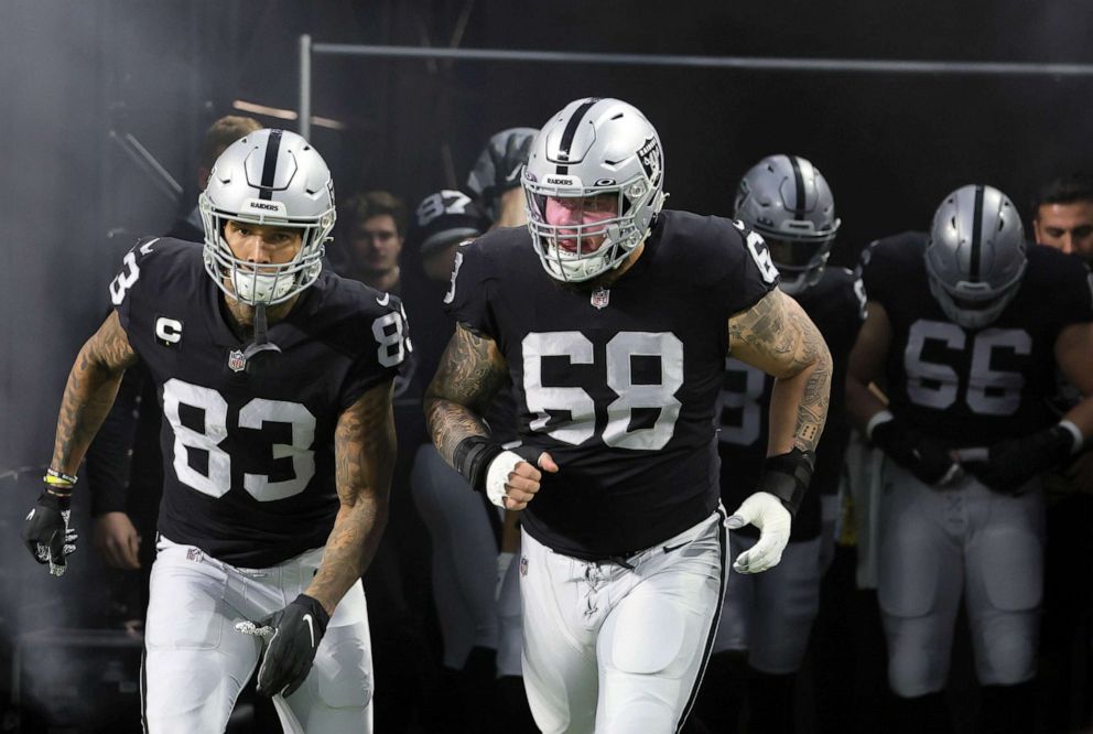 PHOTO: Tight end Darren Waller #83 and center Andre James #68 of the Las Vegas Raiders take the field for warmups before a game against the Los Angeles Chargers at Allegiant Stadium in Las Vegas, Jan. 9, 2022.