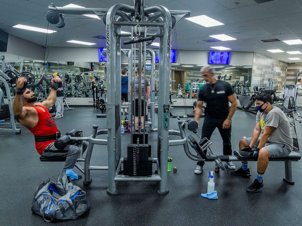 PHOTO: People work out at Fitness Mania, as owner Mike Ends is staying open in defiance of Gov. Gavin Newsom's order that gyms close to slow the spread of the novel coronavirus, in Riverside, Calif., July 14, 2020.