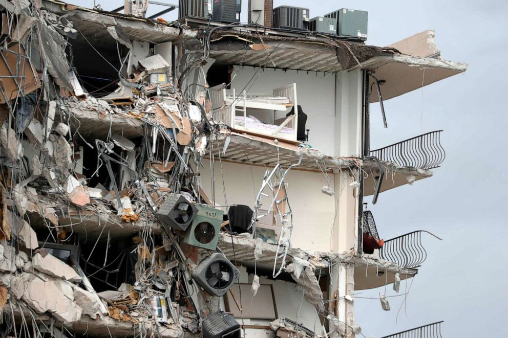 PHOTO: Items and debris dangle from a section of the oceanfront Champlain Towers South Condo that partially collapsed, June 24, 2021, in the Surfside area of Miami, Fla.
