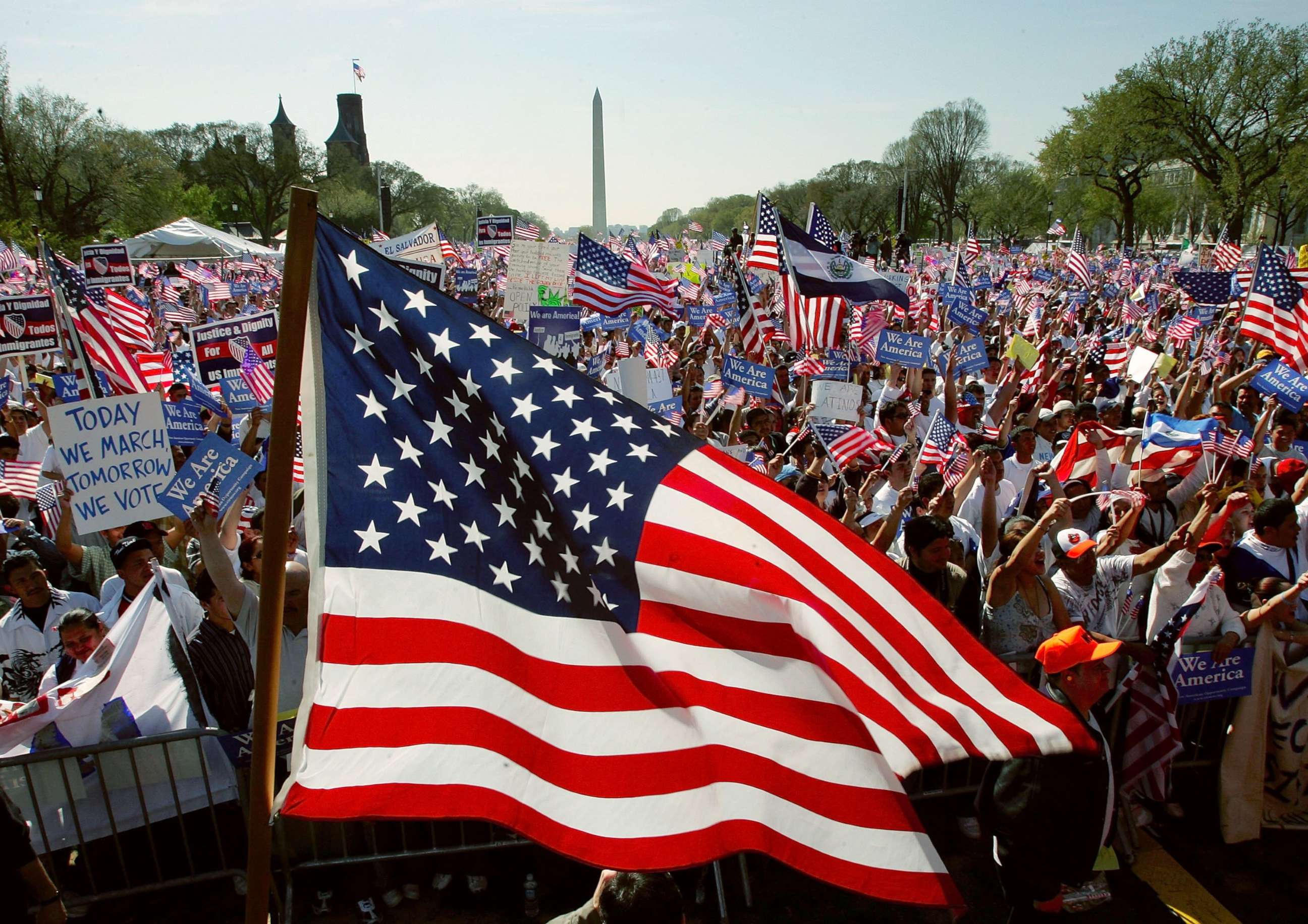 PHOTO: A U.S. flag flies as demonstrators rally during the National Day of Action for Immigrant Justice, or La Marcha, on the National Mall April 10, 2006 in Washington, DC.