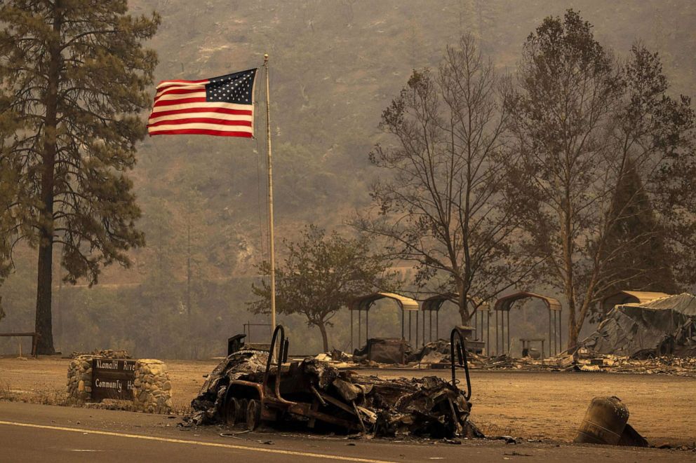 PHOTO: The charred remains of a boat on a trailer, burned in the McKinney Fire, sit under a U.S. flag in the Klamath National Forest northwest of Yreka, Calif.,July 31, 2022.
