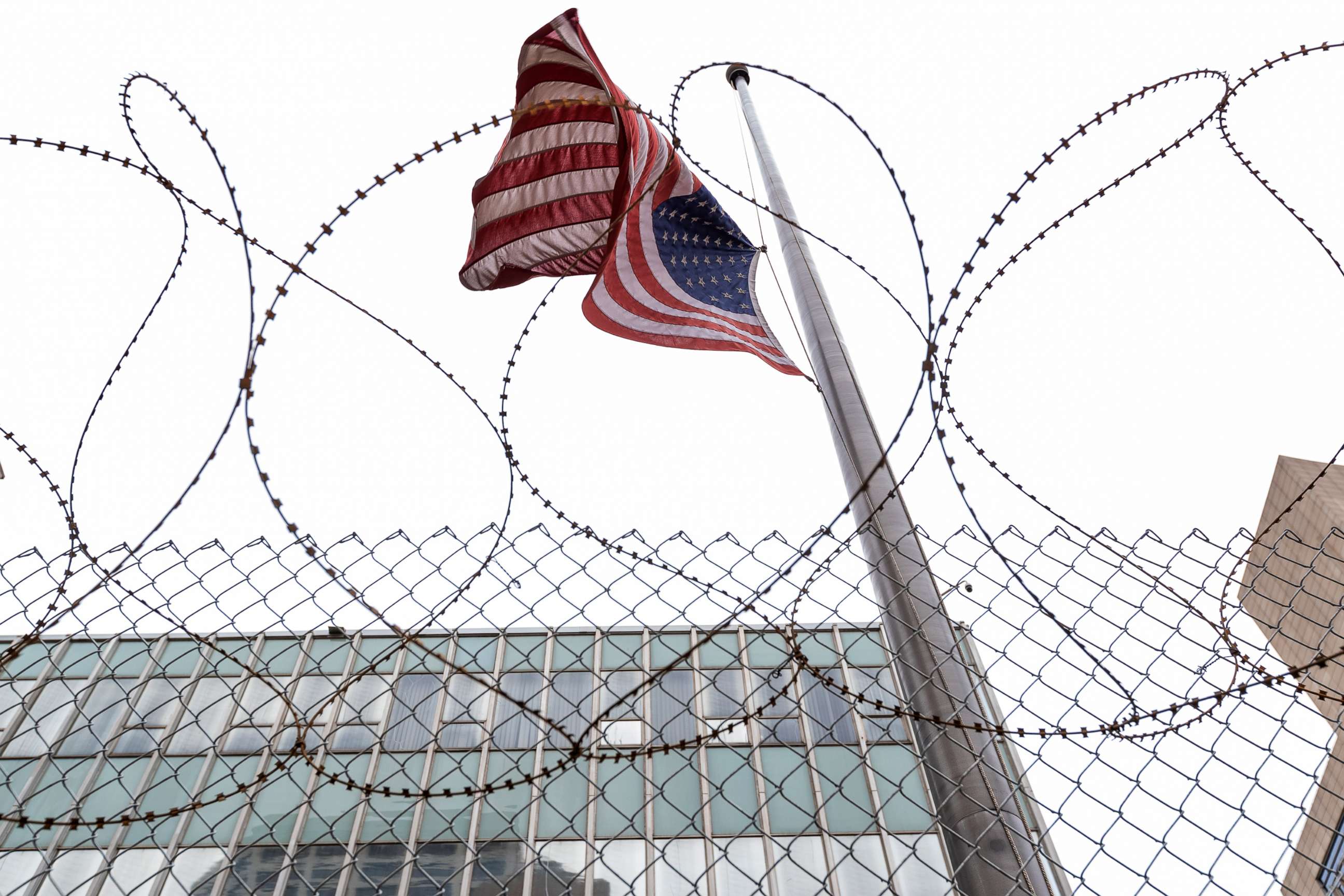 PHOTO: A flag flies behind razor wire and fencing erected in preparation for the verdict in the Derek Chauvin trial, April 18, 2021, in Minneapolis.