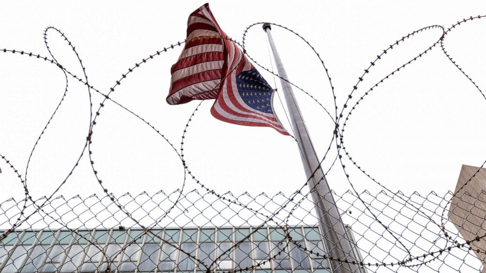 PHOTO: A flag flies behind razor wire and fencing erected in preparation for the verdict in the Derek Chauvin trial, April 18, 2021, in Minneapolis.