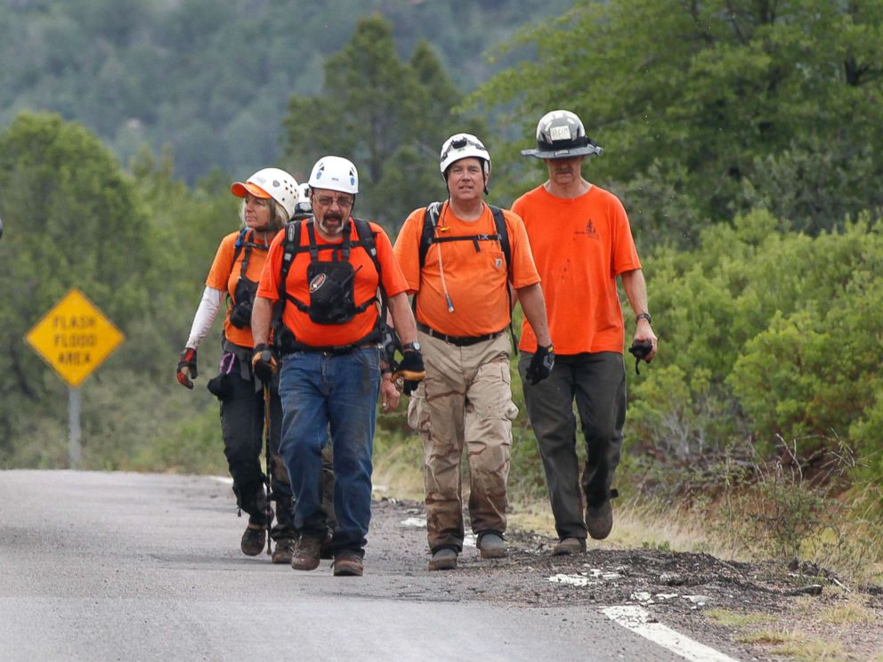 PHOTO: Members of the Tonto Rim Search and Rescue team walk back to the Gila County Sheriff's Office mobile command center after searching along the banks of the East Verde River, July 16, 2017, in Payson, Ariz. 
