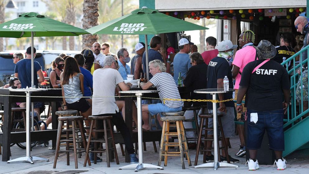 PHOTO: People gather at the Elbo Room bar in Ft. Lauderdale, Fla., Sept. 27, 2020. The governor announced on Friday that Florida moves to phase 3 of coronavirus reopening plan, with bars and restaurants open at full capacity. 