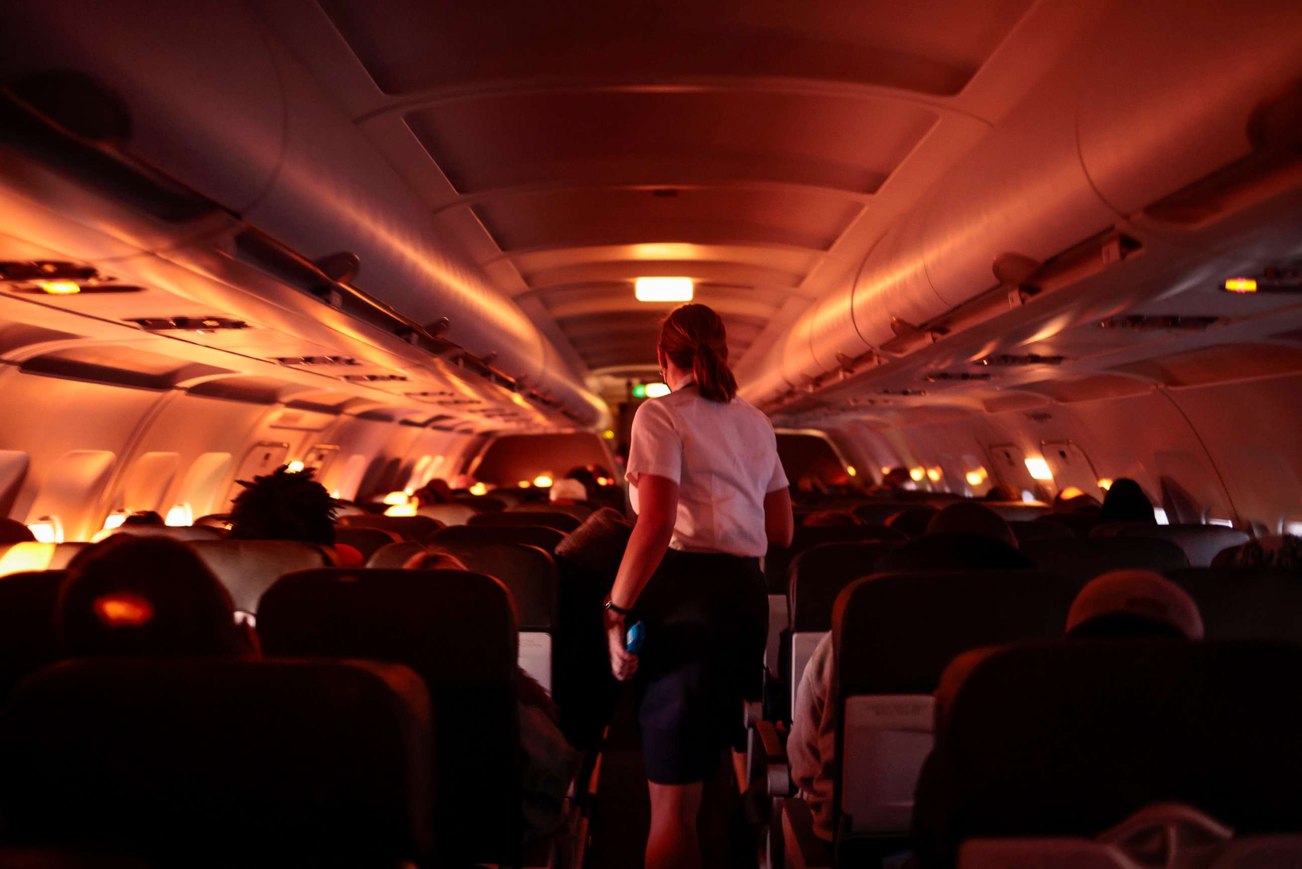 PHOTO: A flight attendant walks through an airplane before the plane's descent into the Dallas/Fort Worth International Airport on Nov. 24, 2021, in Dallas, Texas.