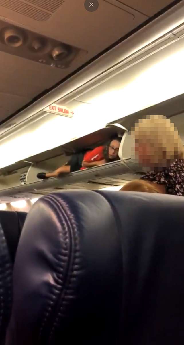 PHOTO: A Southwest Airlines flight attendant was filmed lying inside an overhead bin as passengers boarded a flight from Nashville to Atlanta.