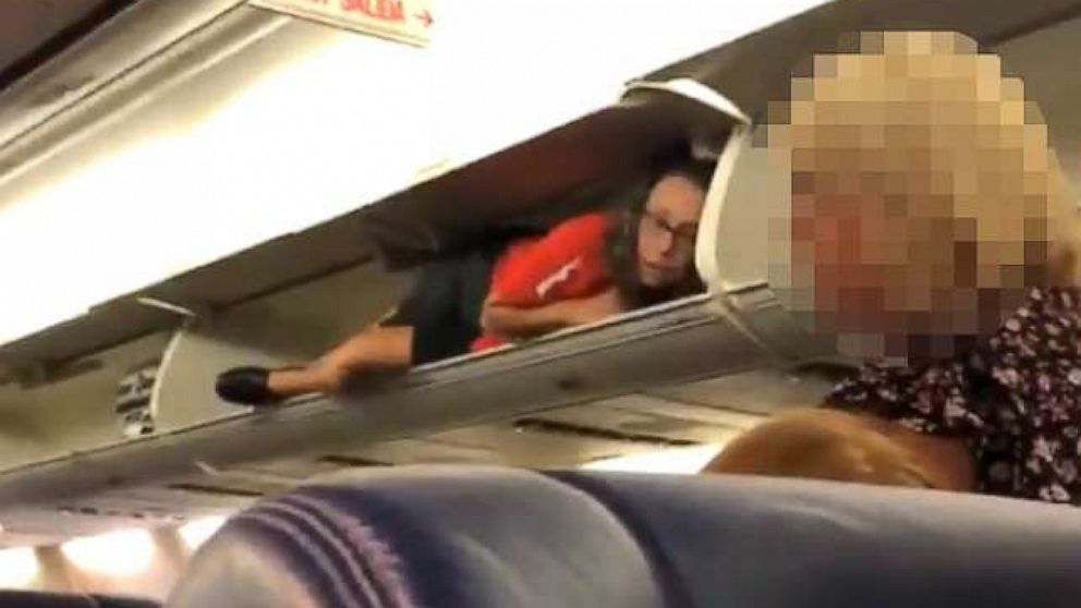 Flight Attendant Filmed Lying Inside Overhead Bin