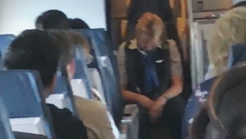 PHOTO: An image made from video shot on board a United Express flight from Chicago to East Bend, Ind., on Aug. 2, 2019, shows a flight attendant who was later charged with criminal public intoxication.